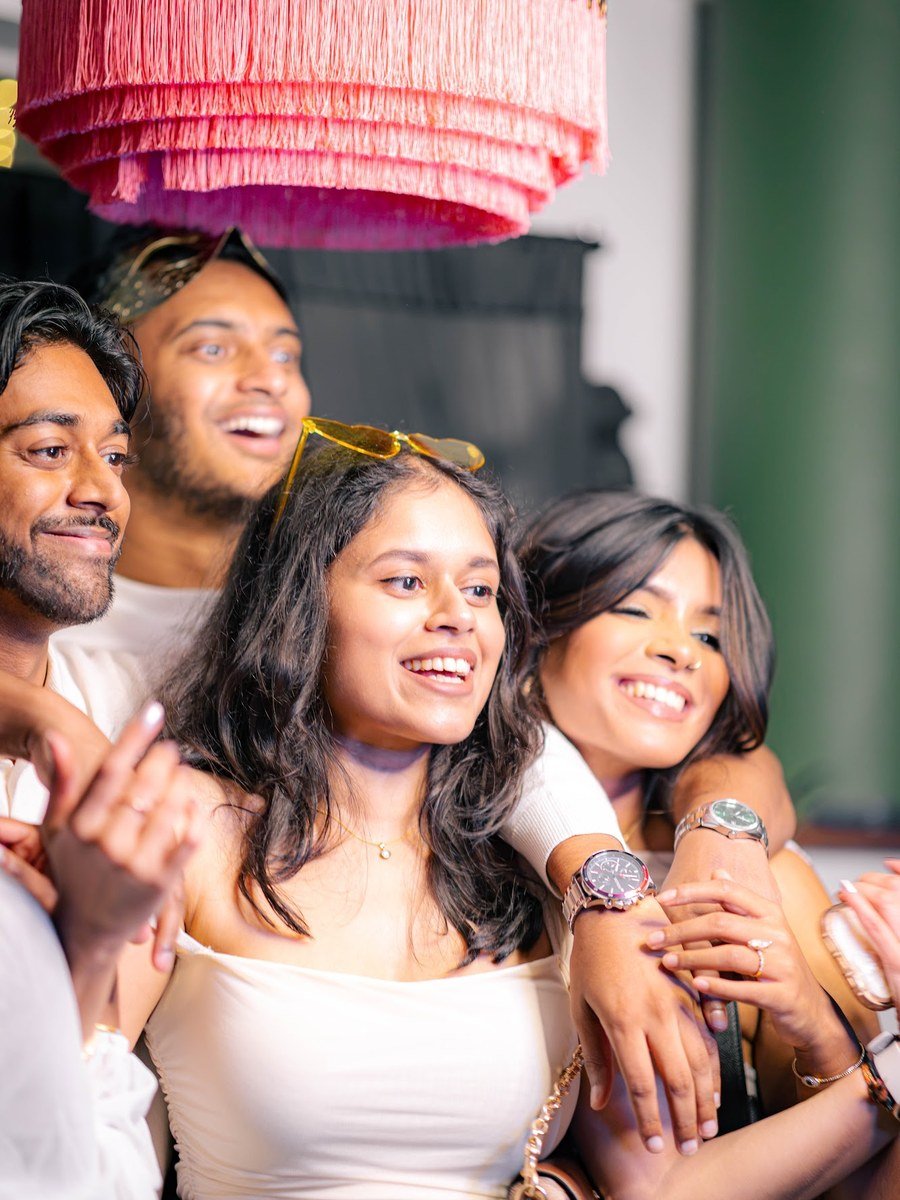 Guests celebrating under the Manjal photo booth lights